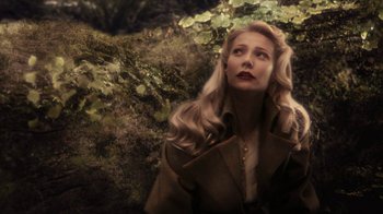 Movie still from “Sky Captain and the World of Tomorrow” (2004), directed by Kerry Conran – A woman with blonde hair wearing a brown coat; Close Up shot, High angle