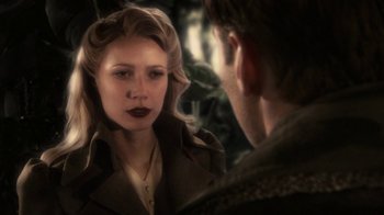 Movie still from “Sky Captain and the World of Tomorrow” (2004), directed by Kerry Conran – A man and a woman looking at one another in a mirror; Close Up shot, Over the shoulder angle