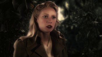Movie still from “Sky Captain and the World of Tomorrow” (2004), directed by Kerry Conran – A woman with blonde hair wearing a trench coat; Close Up shot, Over the shoulder angle