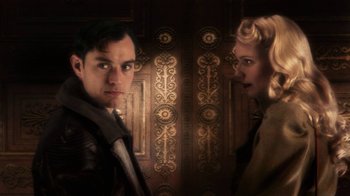 Movie still from “Sky Captain and the World of Tomorrow” (2004), directed by Kerry Conran – A man and a woman standing next to each other in front of an ornate door; Close Up shot, Low angle