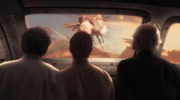 Movie still from “Sky Captain and the World of Tomorrow” (2004), directed by Kerry Conran – Three people looking out of a window at an explosion; Medium shot, Over the shoulder angle