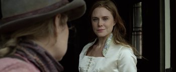 Movie still from “Godless” (2017), directed by Scott Frank – A man and a woman looking at one another in the mirror; Close Up shot, Over the shoulder angle