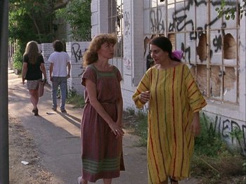 Movie still from “Slacker” (1990), directed by Richard Linklater – Two women walking down the street talking to each other; Wide shot, Over the shoulder angle