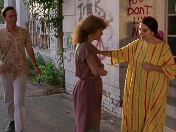 Movie still from “Slacker” (1990), directed by Richard Linklater – Two women are talking to each other on the sidewalk; Medium shot, Over the shoulder angle