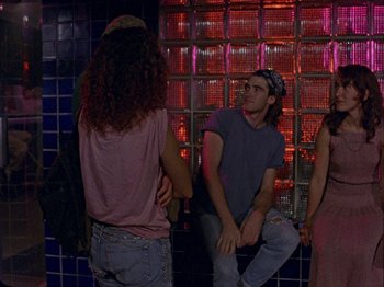 Movie still from “Slacker” (1990), directed by Richard Linklater – A group of young people sitting next to each other; Medium shot, Over the shoulder angle