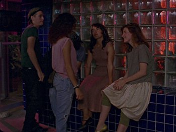 Movie still from “Slacker” (1990), directed by Richard Linklater – A group of young people sitting on a wall next to each other; Wide shot, High angle