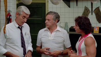 A group of people standing around talking to each other