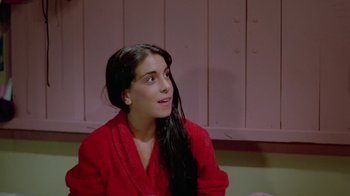 A woman in a red robe looking up at the ceiling