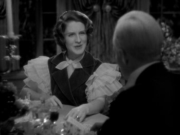 Movie still from “Smilin' Through” (1932), directed by Sidney Franklin – An older woman sitting at a table with a man; Close Up shot, Over the shoulder angle