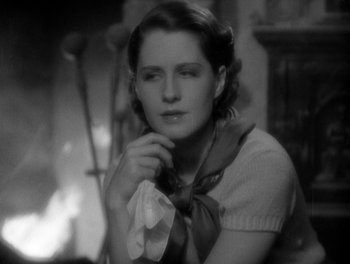 Movie still from “Smilin' Through” (1932), directed by Sidney Franklin – A black - and - white photo of a woman holding a napkin; Close Up shot, High angle