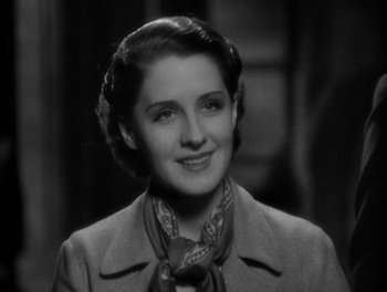Movie still from “Smilin' Through” (1932), directed by Sidney Franklin – An old photo of a woman smiling for the camera; Close Up shot, High angle