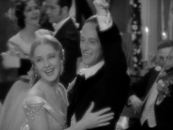 Movie still from “Smilin' Through” (1932), directed by Sidney Franklin – A man and a woman are dancing in a ballroom; Medium shot, Low angle