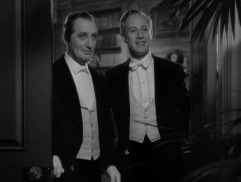 Movie still from “Smilin' Through” (1932), directed by Sidney Franklin – Two men in tuxedos standing next to each other; Medium shot, Low angle