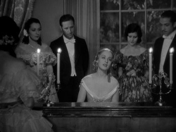 Movie still from “Smilin' Through” (1932), directed by Sidney Franklin – A group of people standing in front of a mirror; Medium shot, High angle