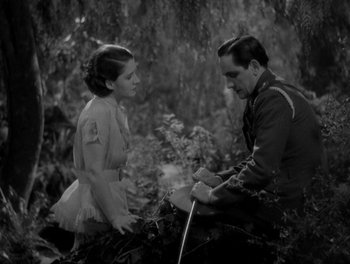 Movie still from “Smilin' Through” (1932), directed by Sidney Franklin – A man and a woman are talking in the woods; Medium shot, High angle
