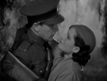 Movie still from “Smilin' Through” (1932), directed by Sidney Franklin – A man and a woman in military uniforms; Medium shot, High angle