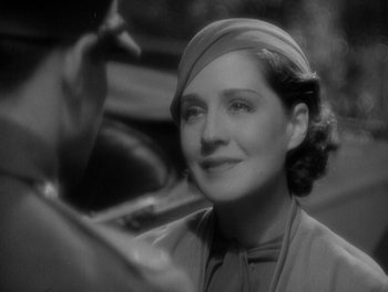 Movie still from “Smilin' Through” (1932), directed by Sidney Franklin – An old photo of a woman in a hat; Close Up shot, Over the shoulder angle