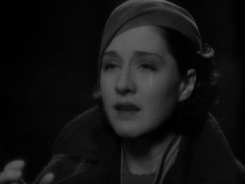 Movie still from “Smilin' Through” (1932), directed by Sidney Franklin – A black and white photo of a woman crying; Close Up shot, High angle