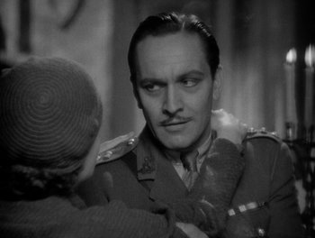 Movie still from “Smilin' Through” (1932), directed by Sidney Franklin – An old photo of a man and a little girl; Close Up shot, Over the shoulder angle