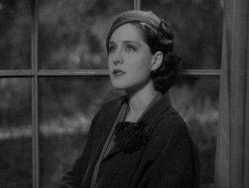 Movie still from “Smilin' Through” (1932), directed by Sidney Franklin – An old photo of a woman looking out of a window; Close Up shot, High angle
