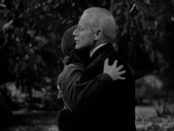 Movie still from “Smilin' Through” (1932), directed by Sidney Franklin – An older man holding a young child in his arms; Medium shot, High angle