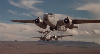 Movie still from “Smokey and the Bandit II” (1980), directed by Hal Needham – Two planes flying in the air over the desert; Wide shot, Low angle