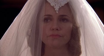 Movie still from “Smokey and the Bandit II” (1980), directed by Hal Needham – A person wearing a wedding veil; Close Up shot, Over the shoulder angle