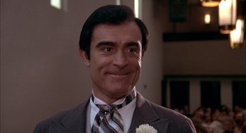 Movie still from “Smokey and the Bandit II” (1980), directed by Hal Needham – A person wearing a suit and tie; Close Up shot, Low angle