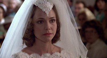 Movie still from “Smokey and the Bandit II” (1980), directed by Hal Needham – A woman wearing a wedding dress and a veil; Close Up shot, Over the shoulder angle