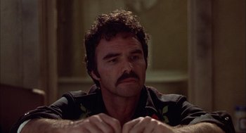 Movie still from “Smokey and the Bandit II” (1980), directed by Hal Needham – A person with a beard and mustache; Close Up shot, Low angle