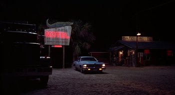 Movie still from “Smokey and the Bandit II” (1980), directed by Hal Needham – A car parked in front of a motel at night; Wide shot, Low angle