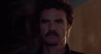 Movie still from “Smokey and the Bandit II” (1980), directed by Hal Needham – A person with a mustache; Close Up shot, Low angle