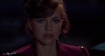 Movie still from “Smokey and the Bandit II” (1980), directed by Hal Needham – A person wearing a purple shirt; Close Up shot, Over the shoulder angle