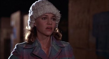 Movie still from “Smokey and the Bandit II” (1980), directed by Hal Needham – A woman wearing a white hat and a plaid jacket; Close Up shot, Over the shoulder angle