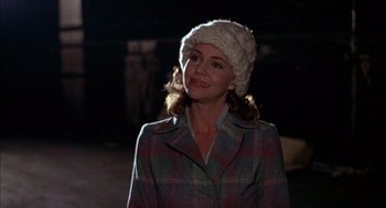 Movie still from “Smokey and the Bandit II” (1980), directed by Hal Needham – A woman wearing a plaid jacket and a white hat; Close Up shot, Over the shoulder angle