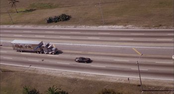 Movie still from “Smokey and the Bandit II” (1980), directed by Hal Needham – An aerial view of a truck and a car on a highway; Extreme Wide shot, High angle