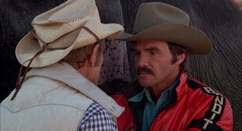 Movie still from “Smokey and the Bandit II” (1980), directed by Hal Needham – Two men in cowboy hats talking to each other; Close Up shot, Over the shoulder angle