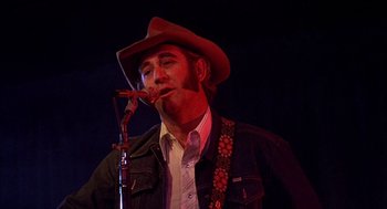 Movie still from “Smokey and the Bandit II” (1980), directed by Hal Needham – A man with a cowboy hat and a pipe in his mouth; Close Up shot, Low angle