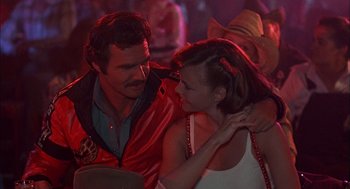 Movie still from “Smokey and the Bandit II” (1980), directed by Hal Needham – A man and a woman are dancing in a club; Medium shot, Over the shoulder angle