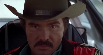 Movie still from “Smokey and the Bandit II” (1980), directed by Hal Needham – A person wearing a cowboy hat; Close Up shot, Low angle