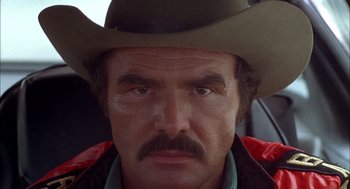 Movie still from “Smokey and the Bandit II” (1980), directed by Hal Needham – A person wearing a cowboy hat; Close Up shot, Low angle