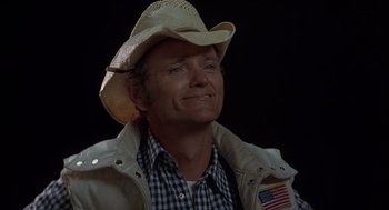 Movie still from “Smokey and the Bandit II” (1980), directed by Hal Needham – A man wearing a cowboy hat and a jacket; Close Up shot, Low angle