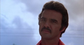 Movie still from “Smokey and the Bandit II” (1980), directed by Hal Needham – A person with a mustache; Close Up shot, Low angle