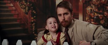Movie still from “Snow Angels” (2007), directed by David Gordon Green – A man and a little girl sitting next to each other in front of a christmas tree; Close Up shot, Over the shoulder angle