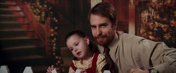 Movie still from “Snow Angels” (2007), directed by David Gordon Green – A man and a little girl playing a video game together; Close Up shot, Over the shoulder angle