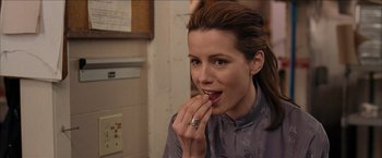 Movie still from “Snow Angels” (2007), directed by David Gordon Green – A beautiful young lady eating a piece of food; Close Up shot, Over the shoulder angle