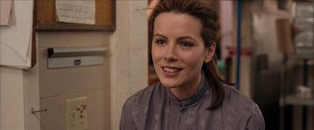 Movie still from “Snow Angels” (2007), directed by David Gordon Green – A person smiling for the camera; Close Up shot, Over the shoulder angle