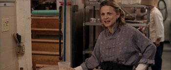 Movie still from “Snow Angels” (2007), directed by David Gordon Green – A woman holding a plastic cup in her hand; Medium shot, Over the shoulder angle