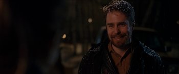 Movie still from “Snow Angels” (2007), directed by David Gordon Green – A man with a beard wearing a jacket with snow on it; Close Up shot, Over the shoulder angle