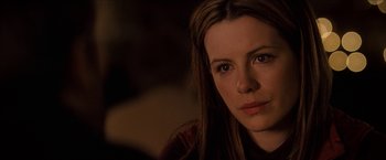 Movie still from “Snow Angels” (2007), directed by David Gordon Green – A person with long brown hair; Close Up shot, Over the shoulder angle